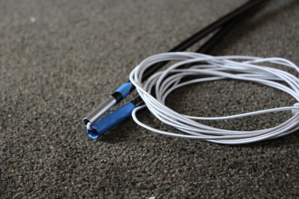 Tent poles and chord shown to illustrate what it looks like on a section that is restrung.